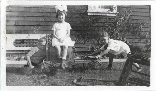 Two boys, a girl and a car.
